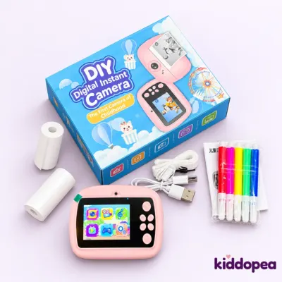 DIY Instant Digital Camera kit: the pink camera, box, paper rolls, cable and colour pens.